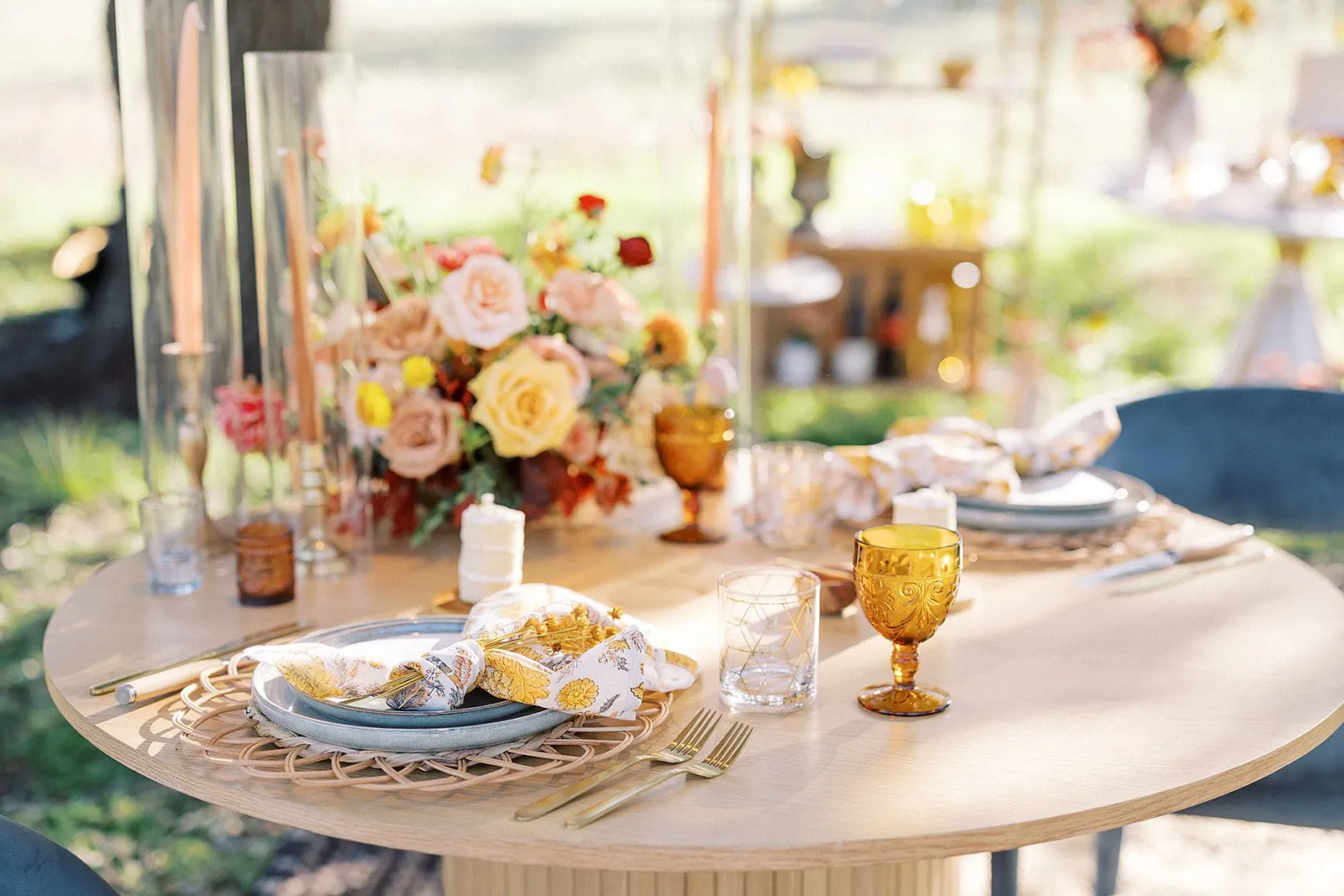 Elegant evening dinner table styled with candles and florals for a 50th birthday