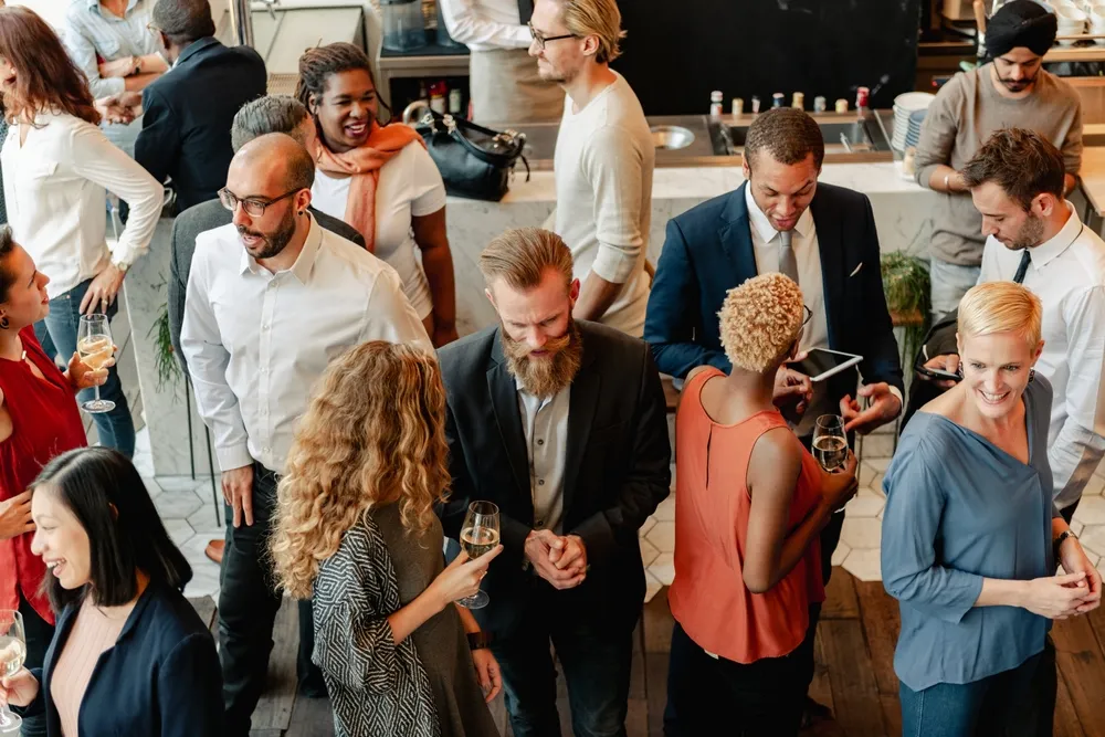 Business team planning a corporate event around a table with laptops