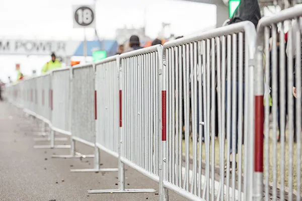 Crowd control barriers and stewards managing a large event