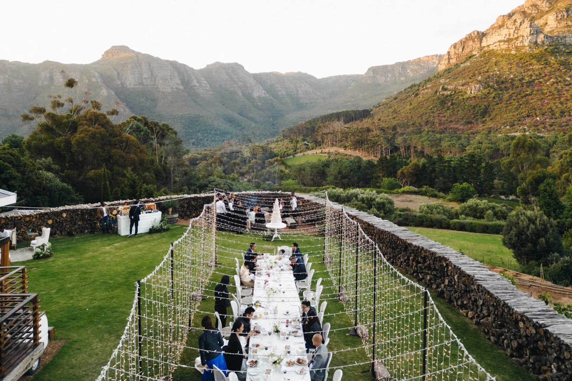 Elegant outdoor reception set up on a Cape Winelands estate with mountain backdrop