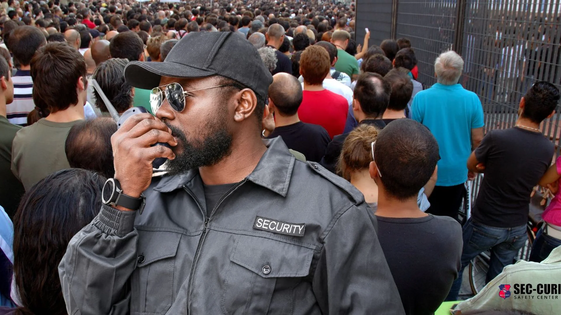 Event safety officers and crowd-control barriers at a large public gathering