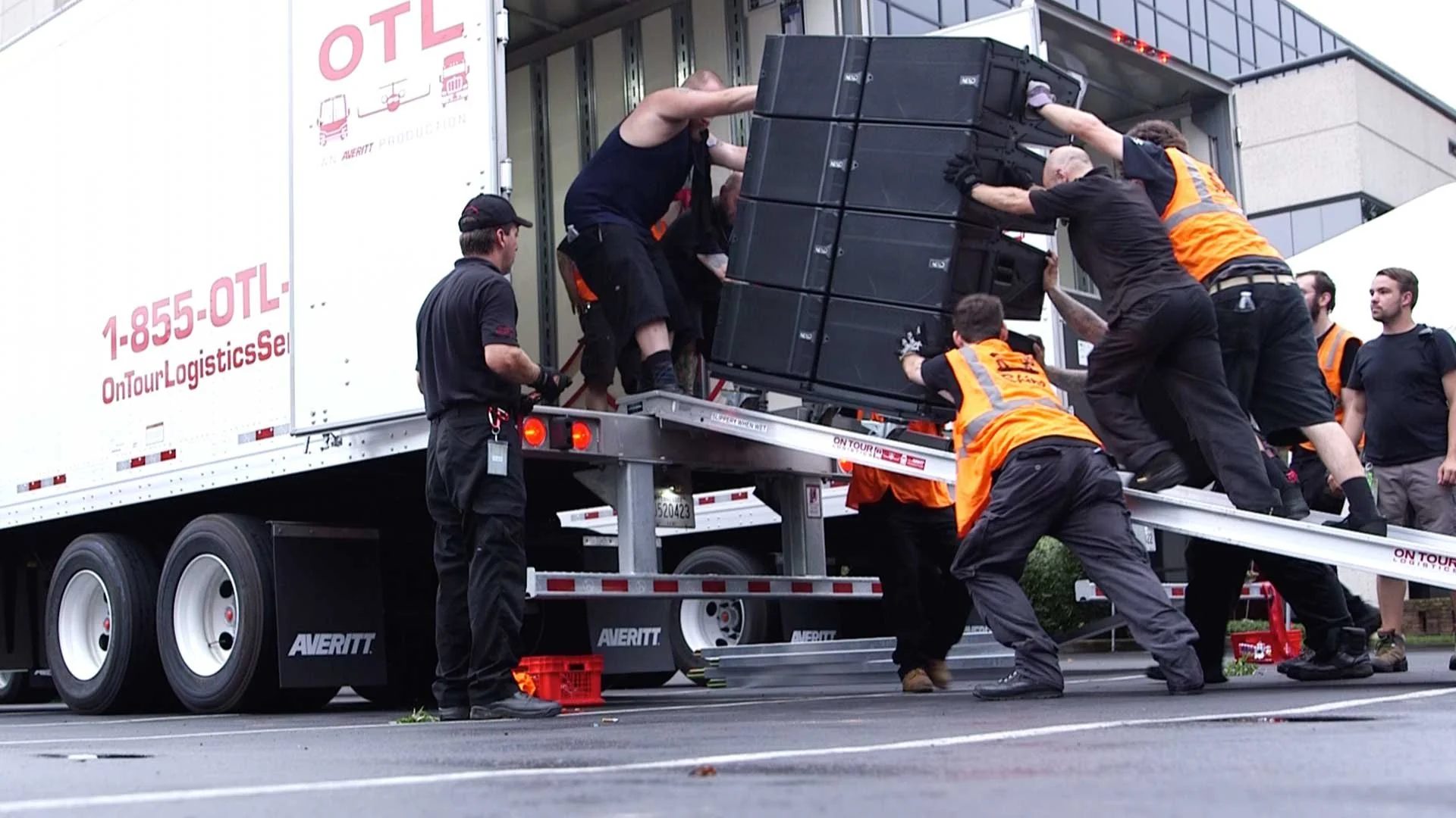 Event production trucks loaded with staging equipment and lighting gear for a touring concert