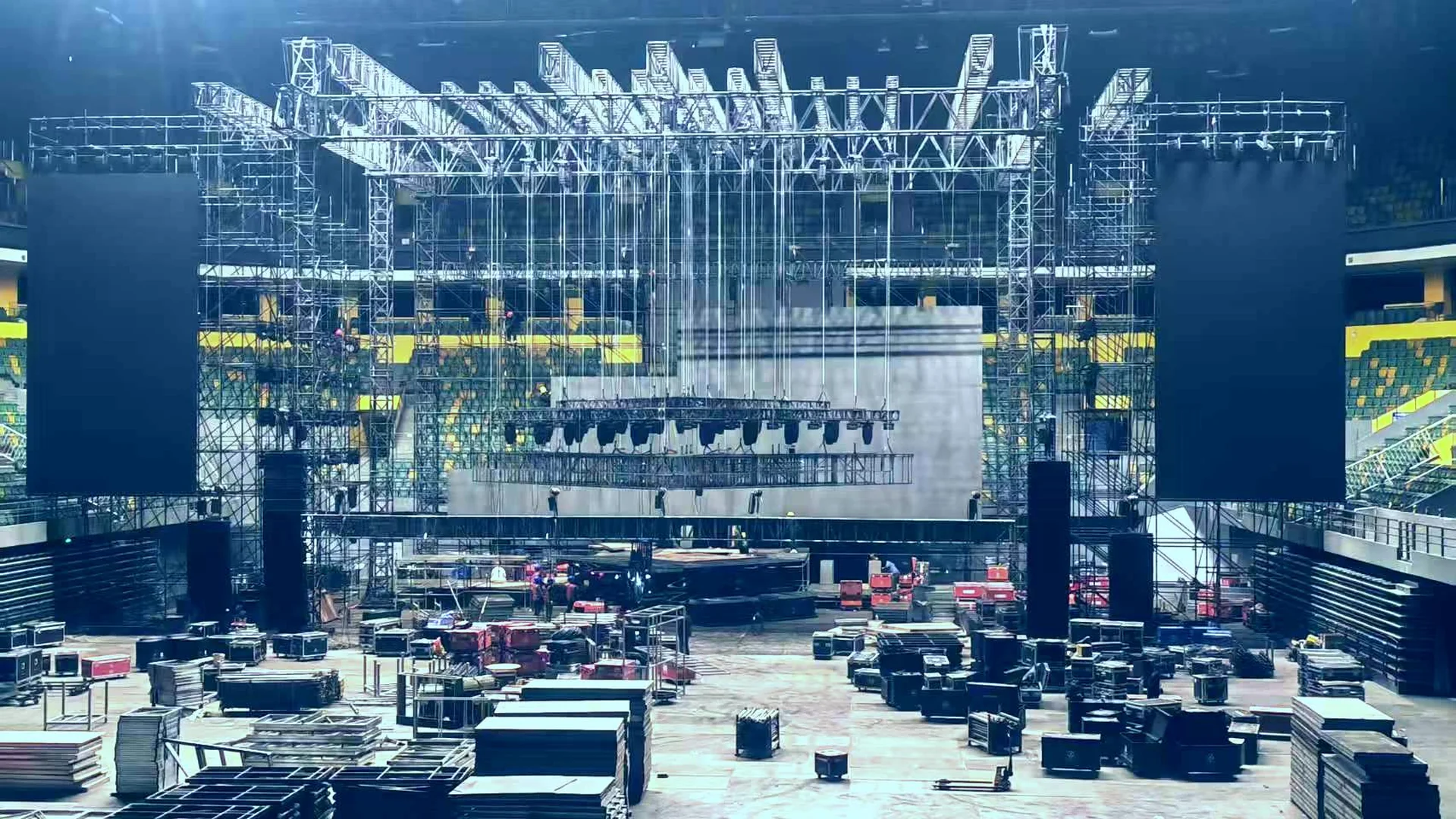 Concert stage with professional lighting rigs, LED walls and truss systems during a live technical production
