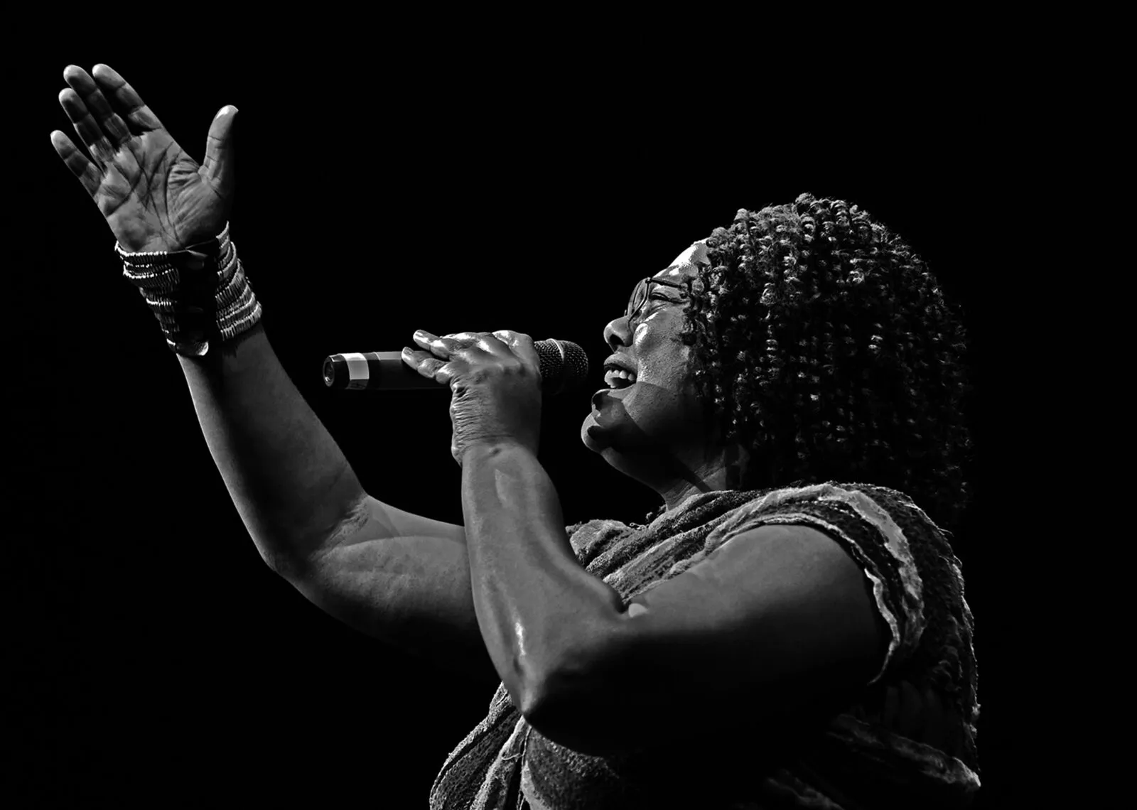 Live female vocalist performing on stage at a B&W Productions event, black and white