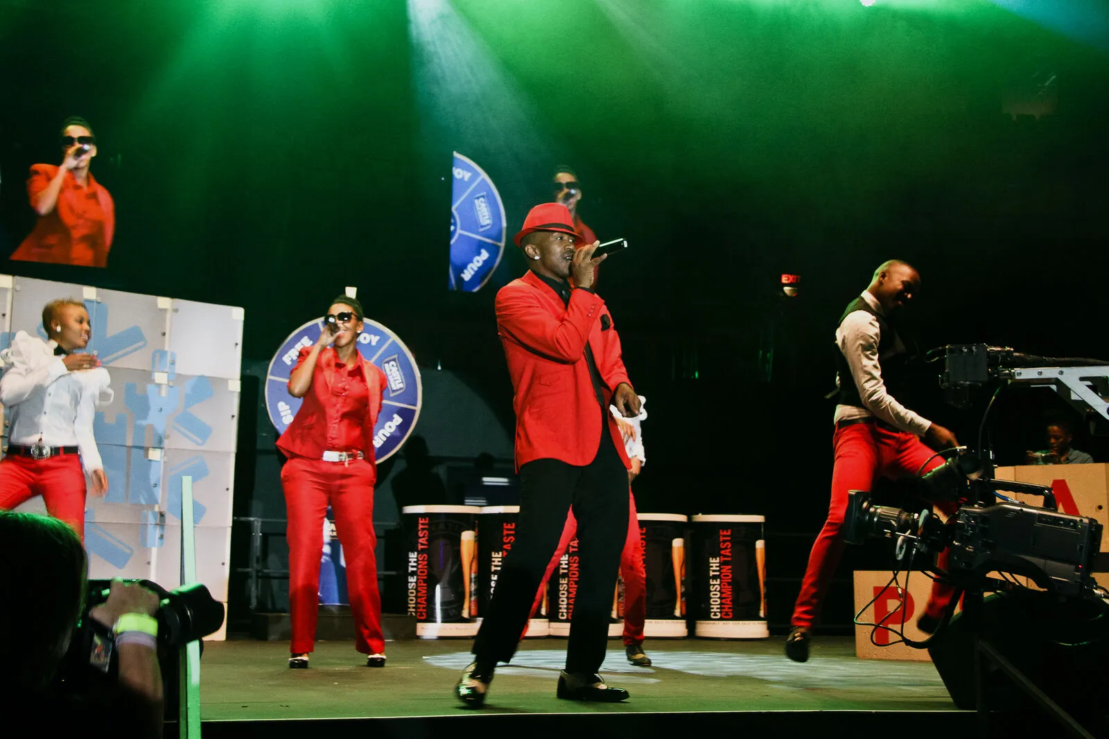 Choreographed red-suit performers on a B&W Productions concert stage