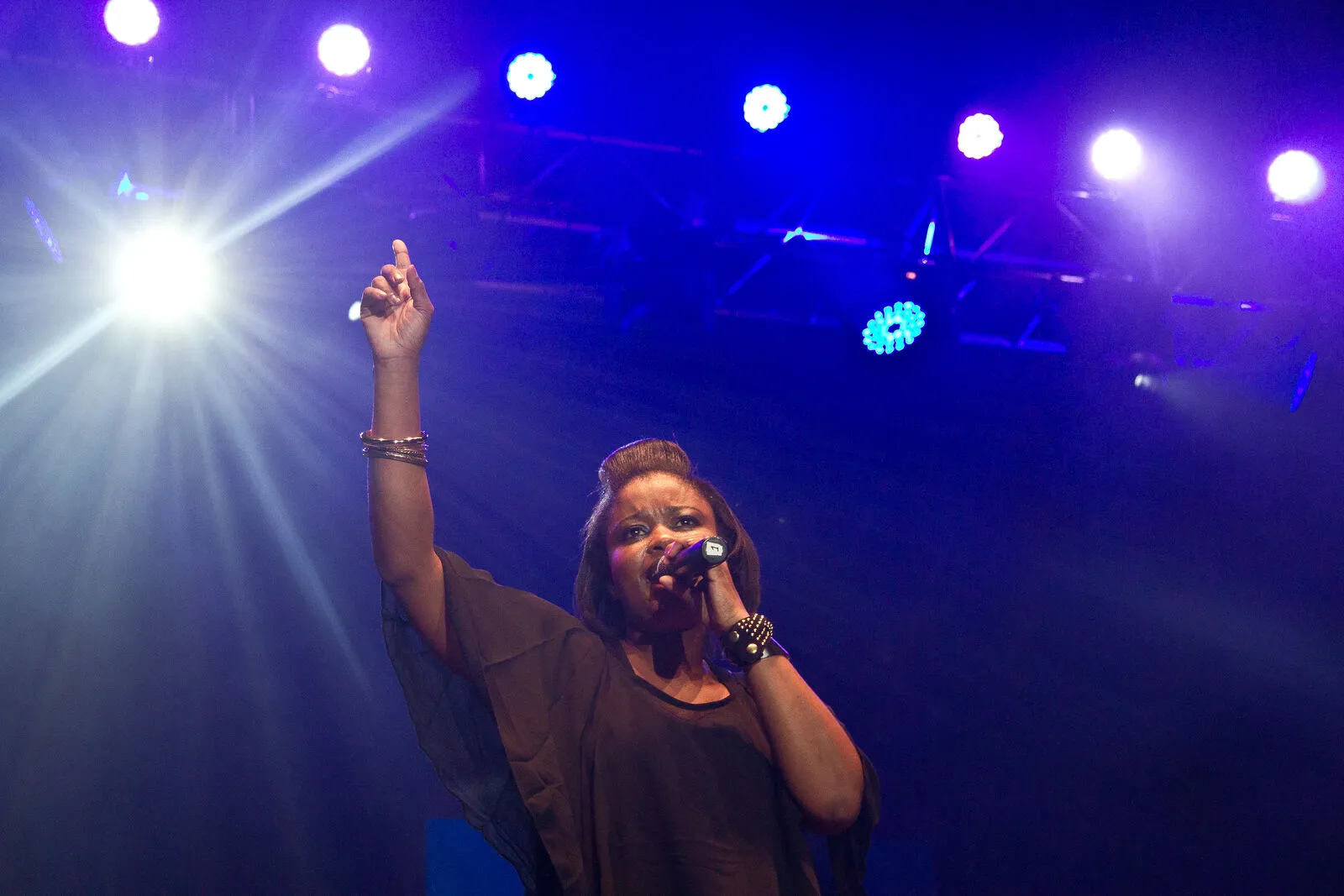 Female vocalist performing under blue stage lights at a B&W Productions event
