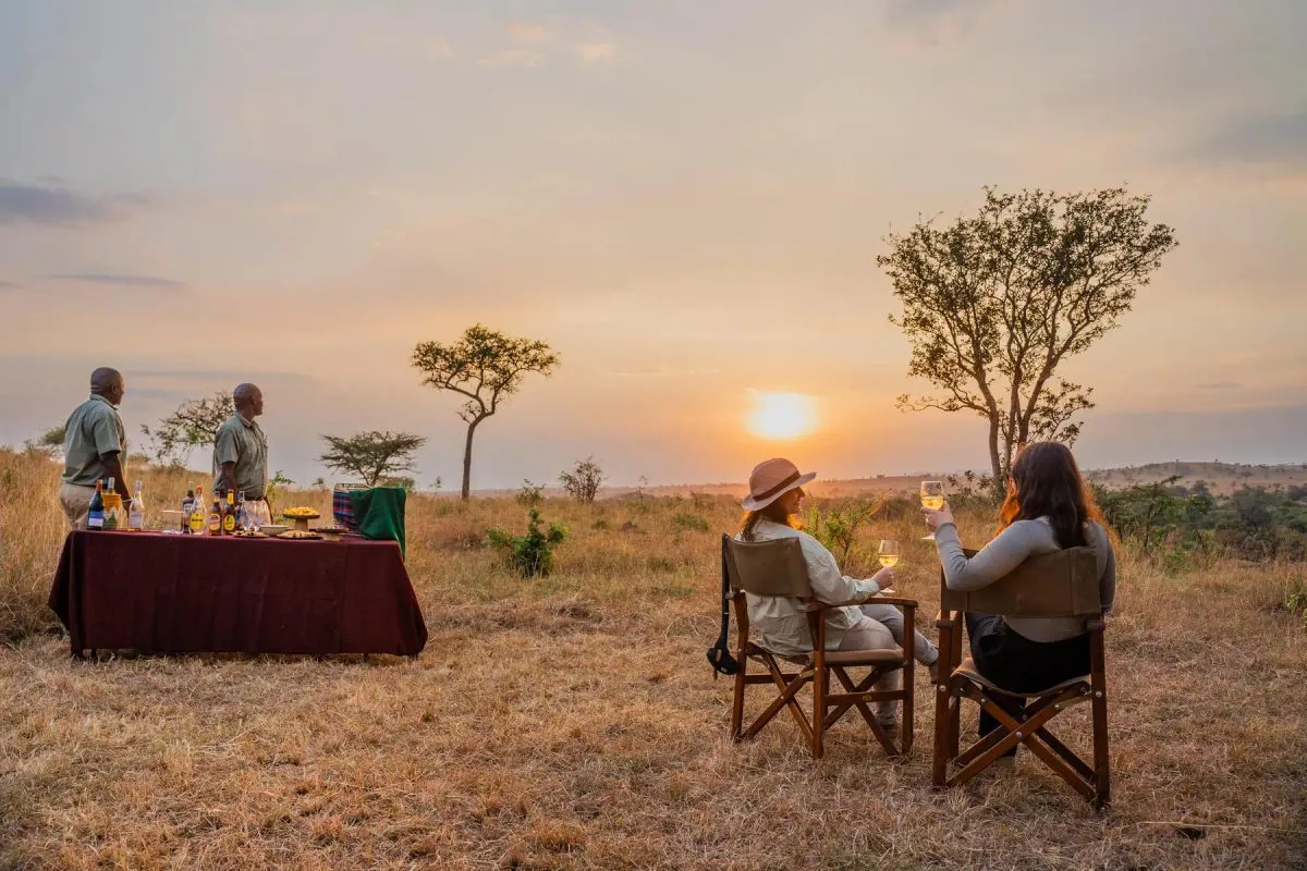 Guests enjoying sundowners in the South African bushveld at a safari-style birthday celebration