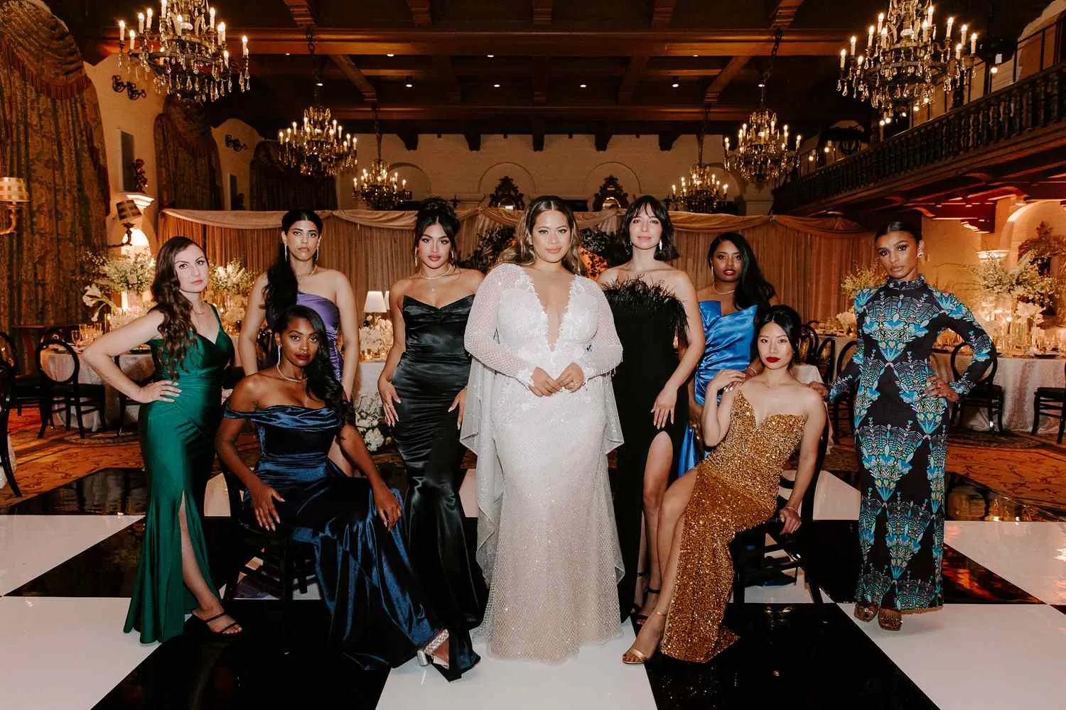 Women in glamorous gowns at an elegant masquerade-style themed party
