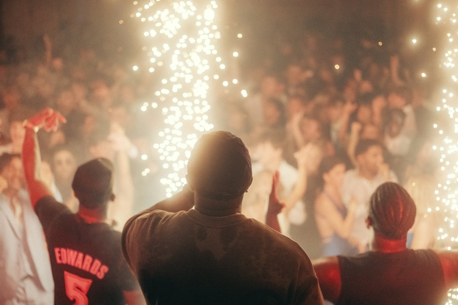 An upscale evening celebration with dramatic lighting and a crowd on the dance floor