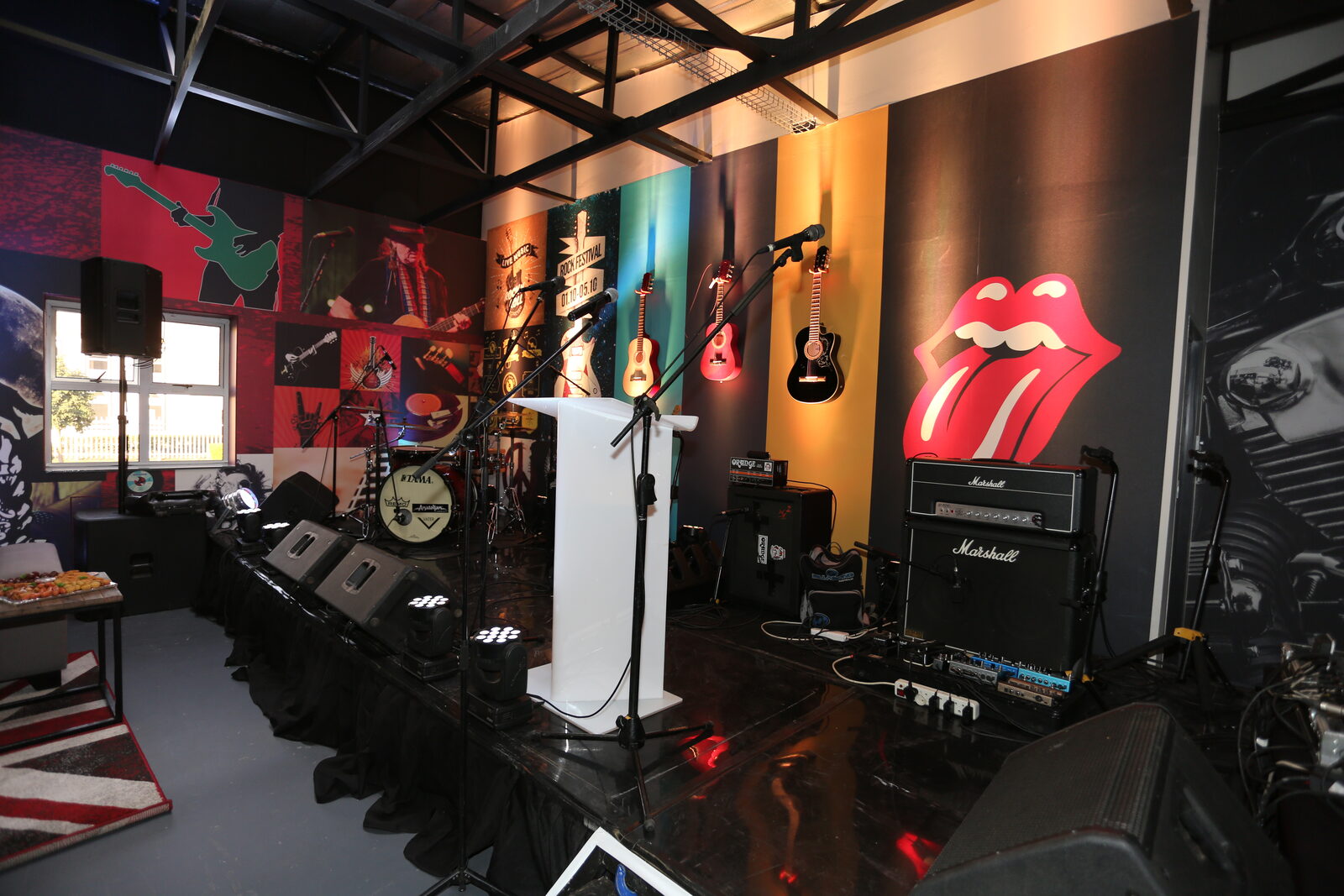 Rock-themed venue with Rolling Stones décor — stage view
