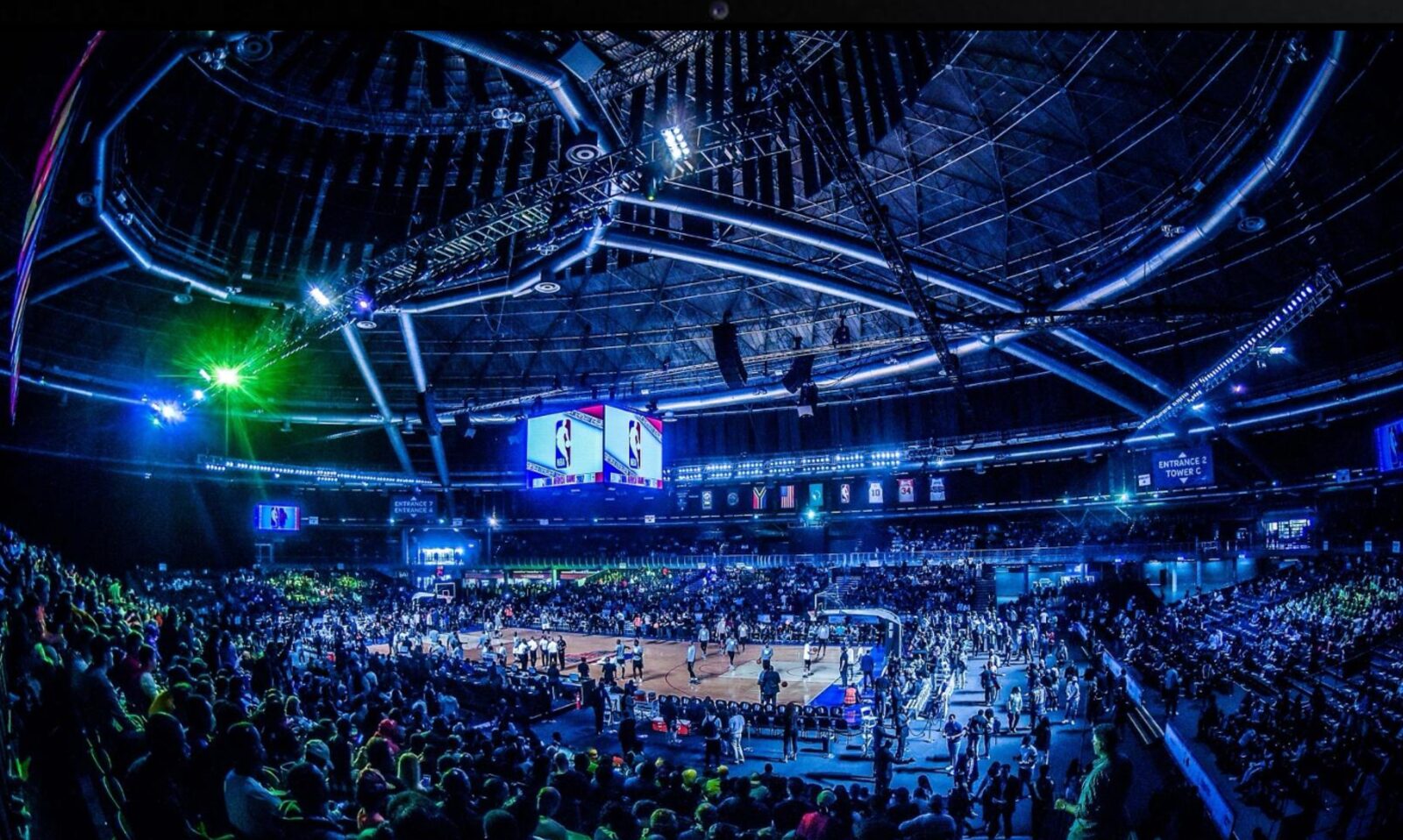 NBA arena activation — full house under stage lighting