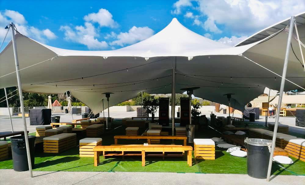 A spacious tent set up with tables and chairs available for hire in Johannesburg.