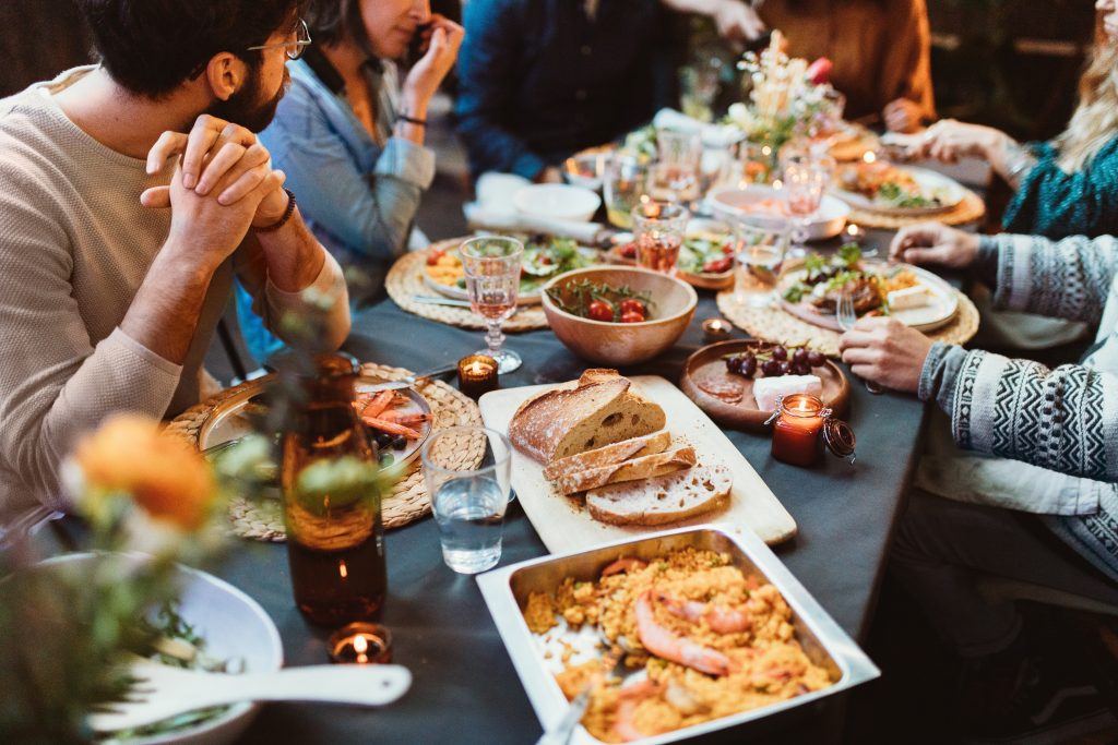 An event theme idea featuring a group of people sitting around a table with food.